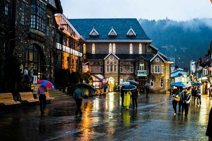 Locals and tourists walking on the Mall Road in Shimla in the rain