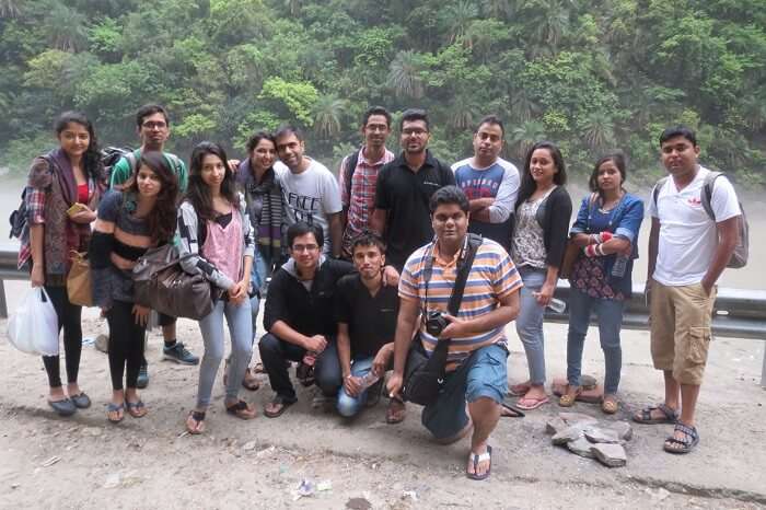 A group of travelers pose for a group photo on one of the weekend trips from Delhi to Tirthan Valley