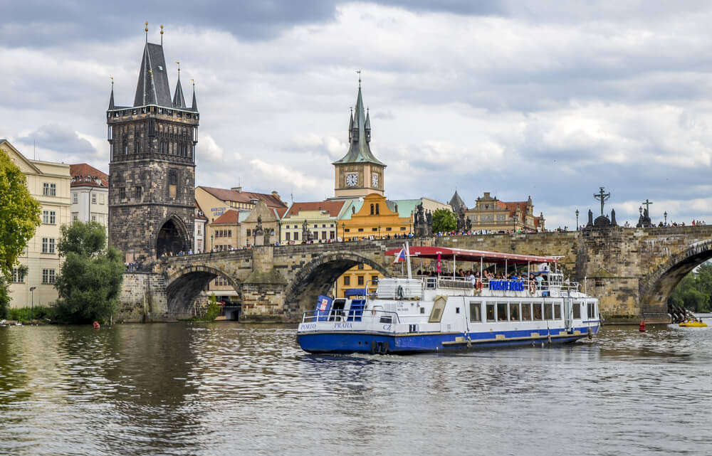 A view of a cruise on the river Vltava with the Charles Bridge in the background