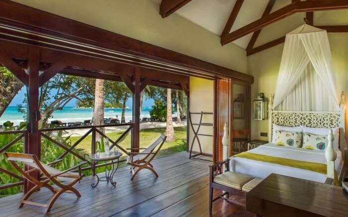 A beautiful room with two wooden chair overlooking the sea