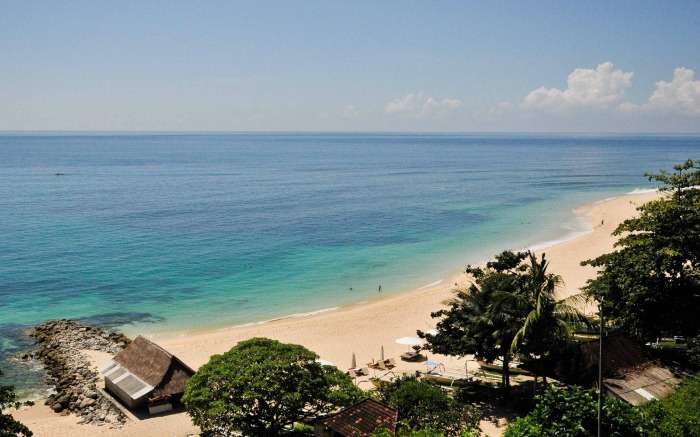 A brown sandy beach with neverending blue waters 