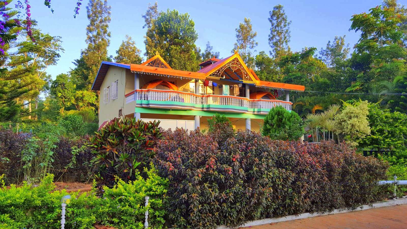 a colorful homestay surrounded by a garden 