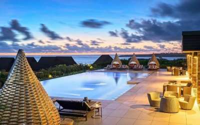 Stylish bamboo cabanas near an infinity pool in a resort