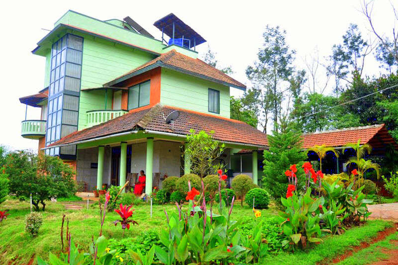a Karnataka style home painted green