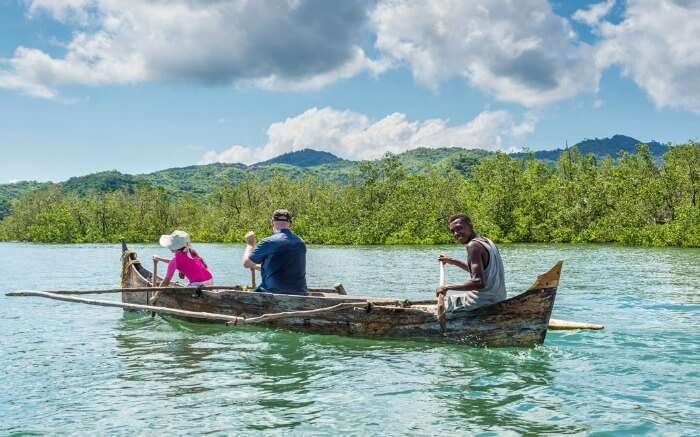 Tourists taking a pirogue ride across a river in Madagascar