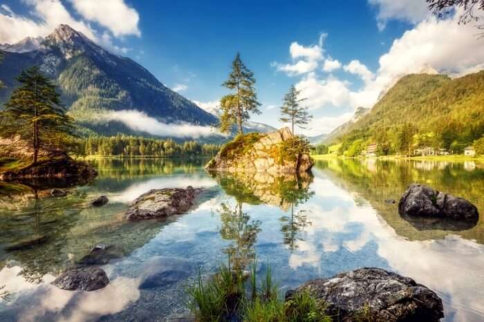 Lake Hintersee exemplified by see through water, guarding mountains and floating mist