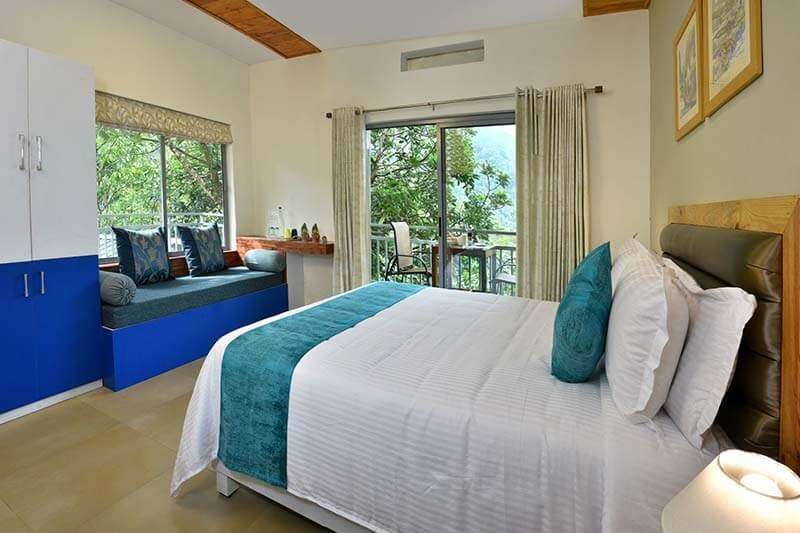 a bed inside a hotel room with blue comforter