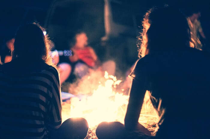 A group of friends enjoying bonfire party on a weekend trip