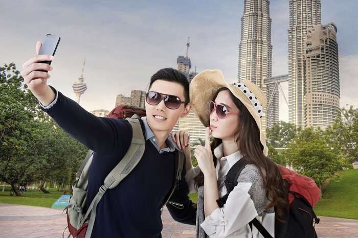 Asian couple travel and take selfie in Kuala Lumpur