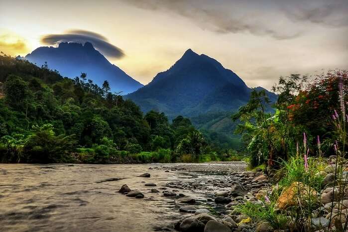 A view of Kinabalu Mountain in the background of the village Of Tambatuon in Borneo district of Sabah with an amazing rare cloud formation on the top of it