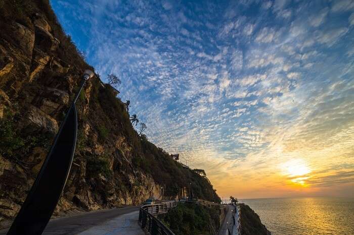 A sunset shot of a road by the coast at Acapulco