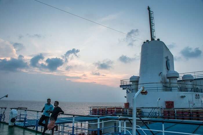 Passengers on deck of MV Kavaratti at sunset
