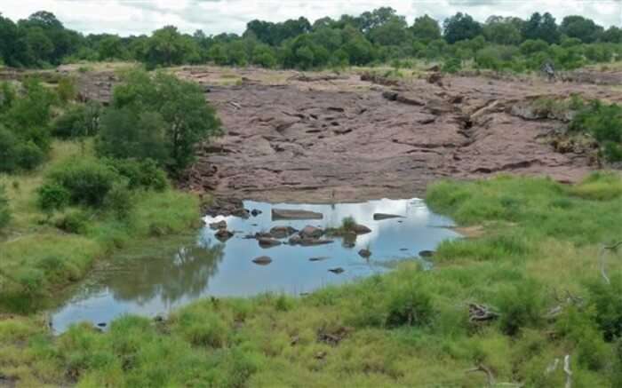 Red Rocks surrounded by dense forest in Nxanatseni Region in Kruger 