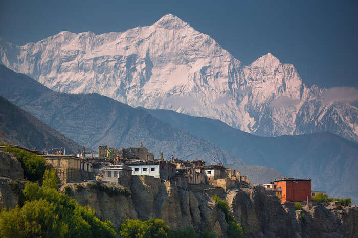 Tibetan style home and snow clad mountains during Upper Mustang Trek