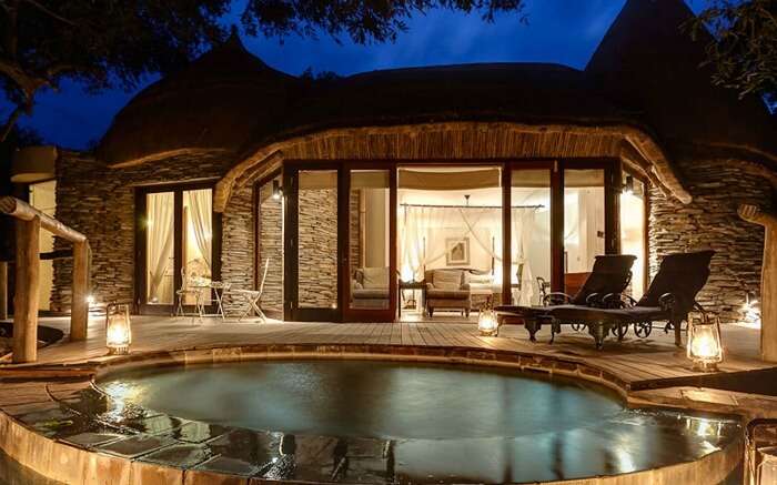 Well lit interiors and front pool view of Tintswalo Safari Lodge in Kruger National Park 