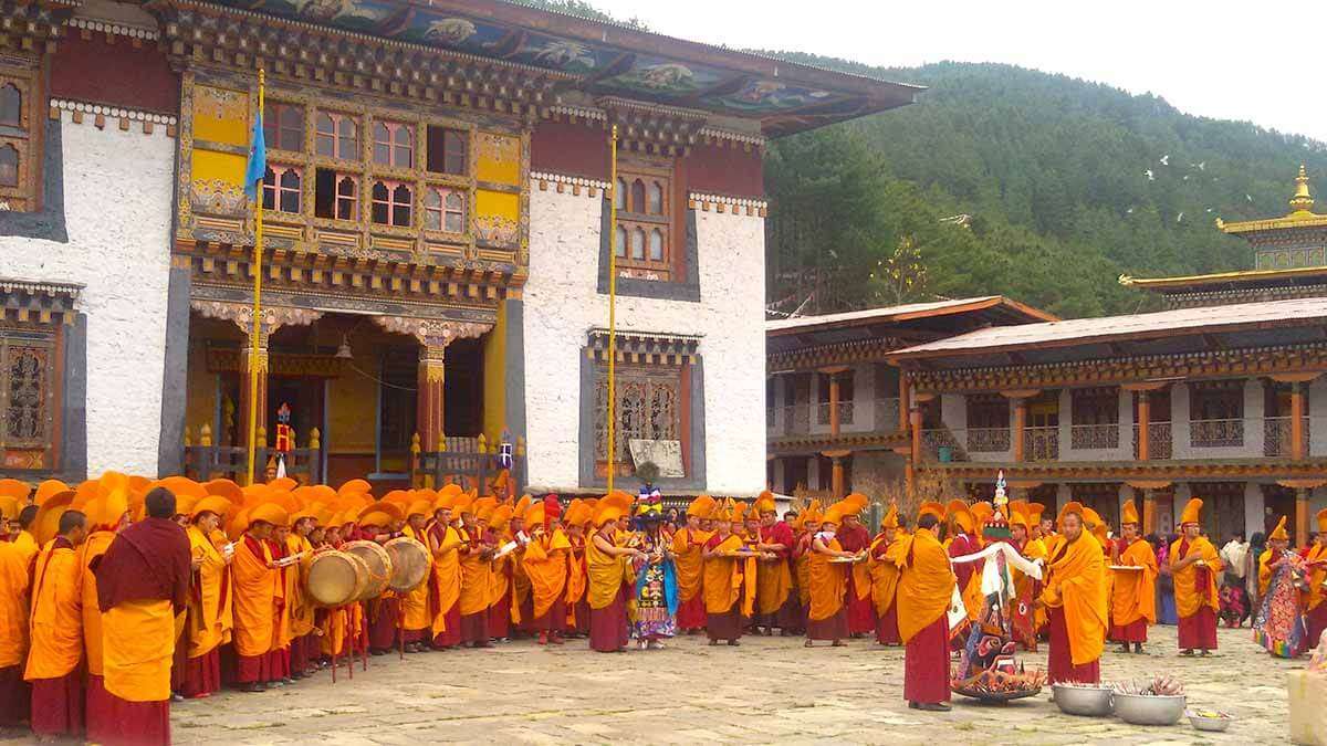 monks wearing orange robs in a monastery in Bhutan