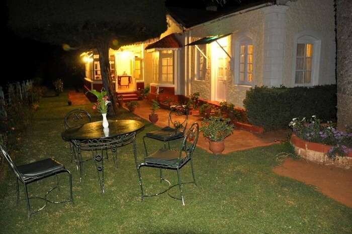 A nightshot of the garden at the Wyoming Heritage Colonial Bungalow in Ooty