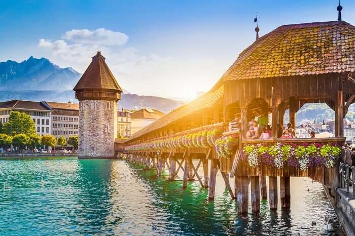 Historic city center of Lucerne with famous Chapel Bridge and Mount Pilatus summit in the background