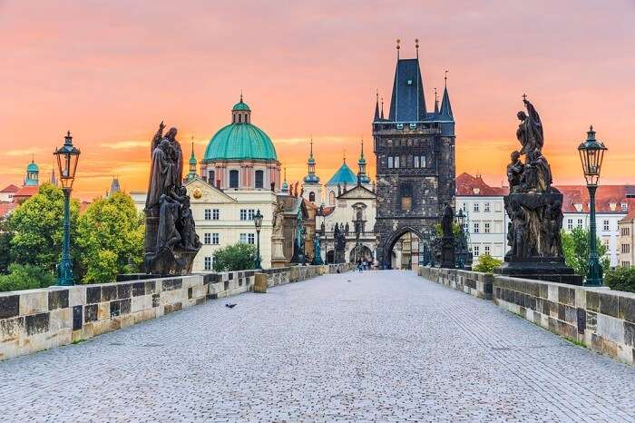 Charles Bridge and Old Town Tower at sunrise at Prague in Czech Republic