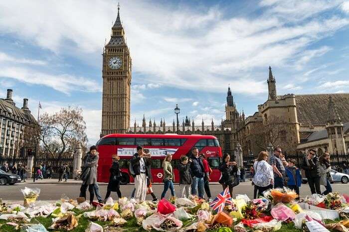 A bus passing by the Big Ben Tower on the Westminster Bridge in London