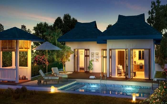 A view of Amaras Villa with a pool in Lonavala at sunset