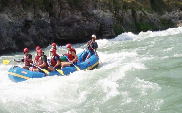 Adventurers cruising on a water stream in Marshyangdi in Nepal