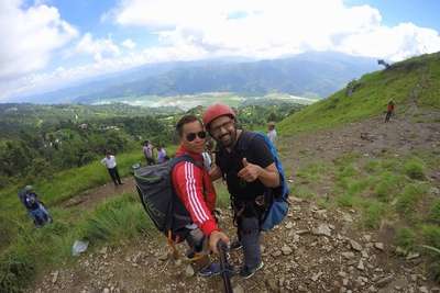 narayan and his paragliding guide in nepal