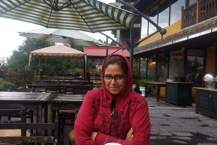 narayan's wife sitting at cafe in hotel country villa