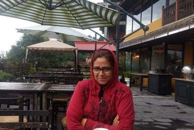 narayan's wife sitting at cafe in hotel country villa