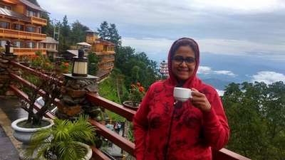 narayan's wife having tea before splendid views from hotel country villa