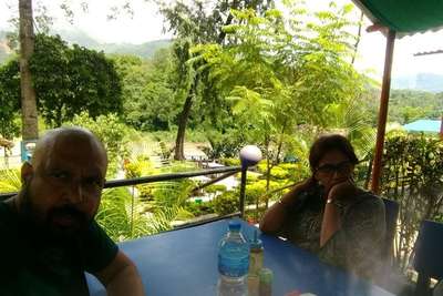 narayan and his wife having lunch at riverside restaurant on their nepal holiday
