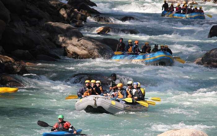 Rafting boats moving together in a stream in Trishuli River in Nepal