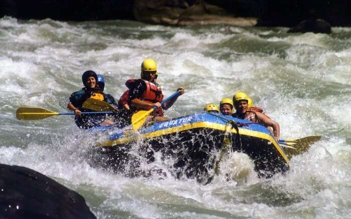 Thrilled adventurers on a boat in Sun Koshi River in Nepal