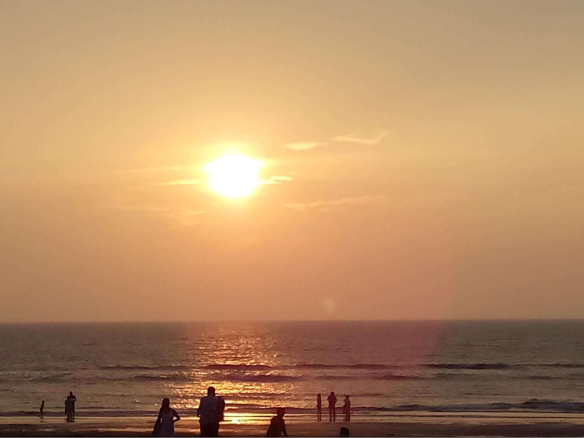 people enjoying a sunset at a beach