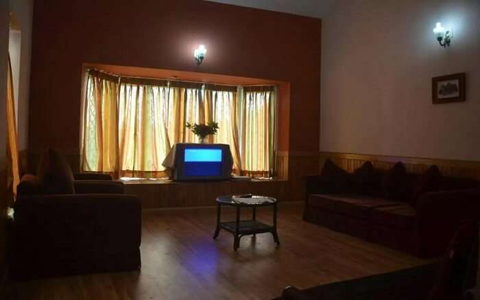 A bedroom in a cottage with a TV and lights