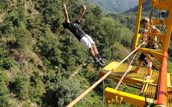 A boy in black t-shirt trying bungee jumping in Rishikesh 