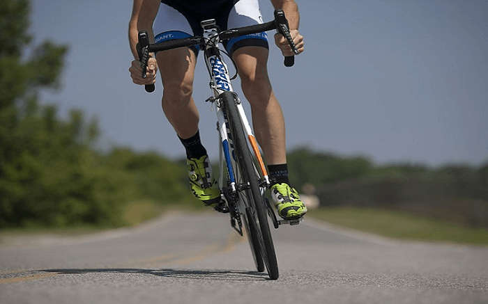 A man riding cycle on road 