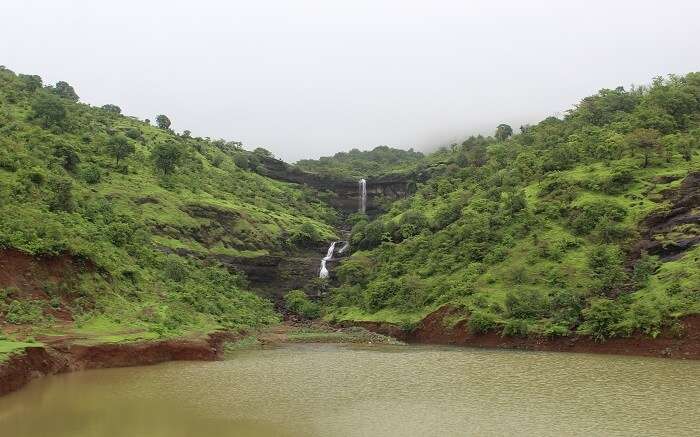 A waterfall amid green valleys