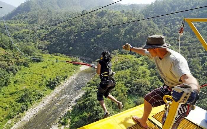 A woman in black bungee jumping in Rishikesh