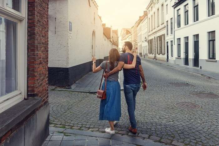 a couple walking through the streets of Belgium on their honeymoon
