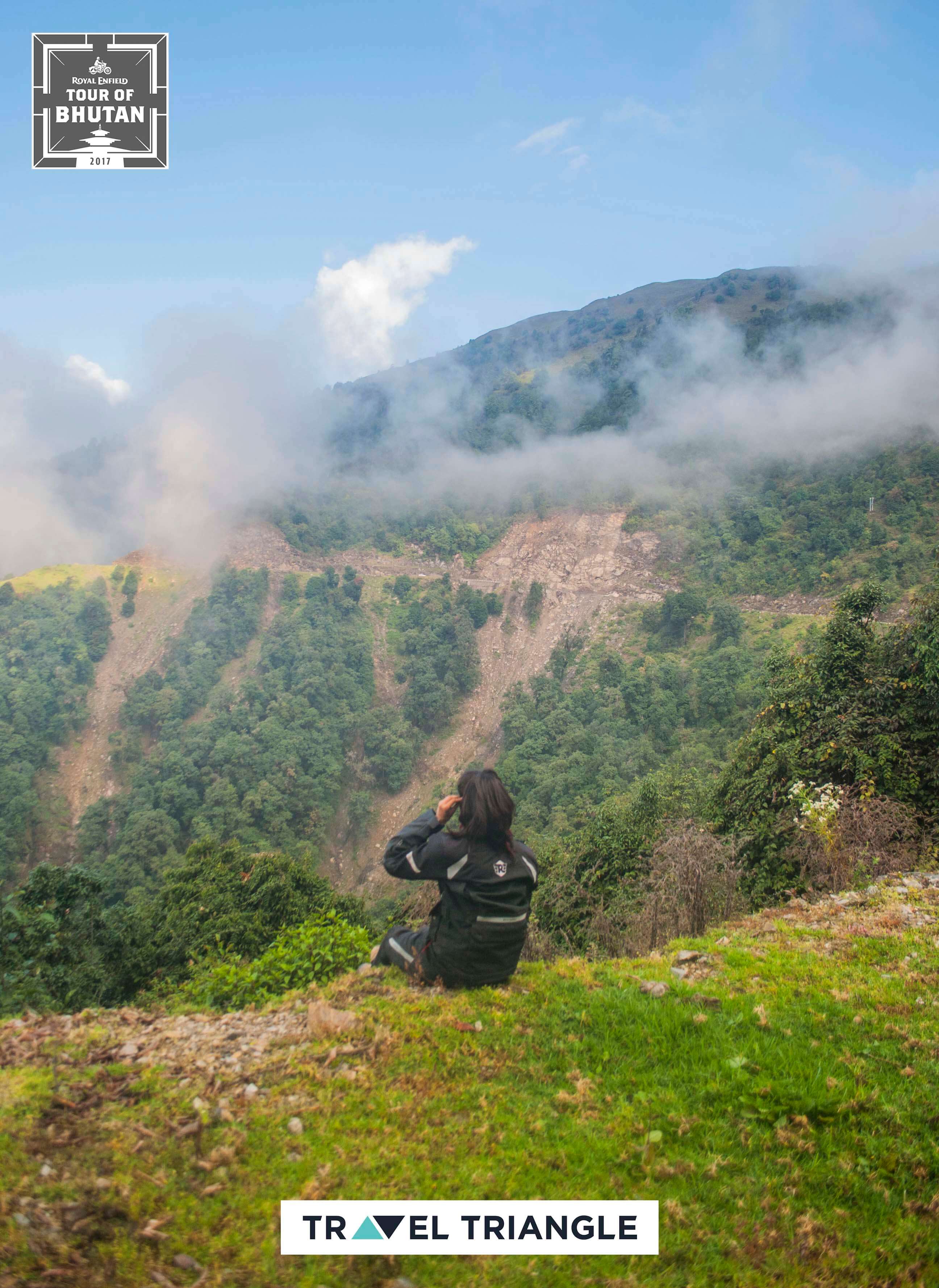 Trashigang to Samdrup Jongkhar: a female rider sitting on the edge of a hill