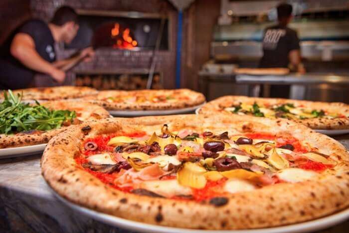 eat different kinds of pizzas at Pizzafest