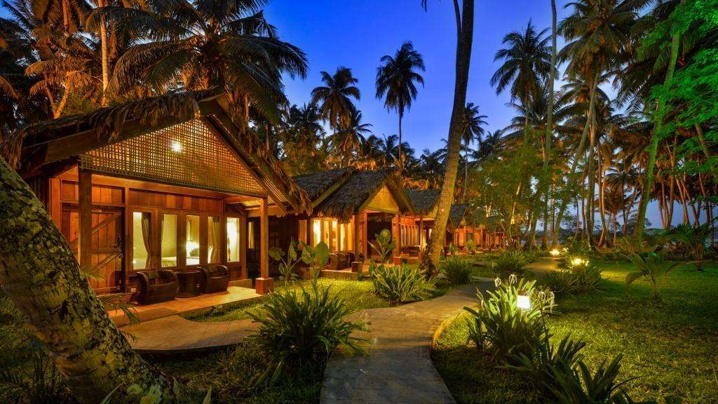 a beautifully lit resort surrounded with palm trees