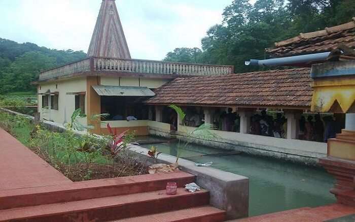 a n old temple with a small pond 