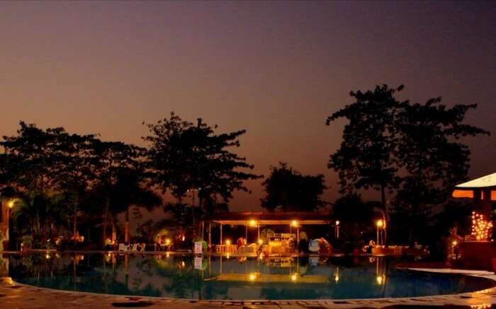 A pool view of River Winds Resorts in Mumbai at night