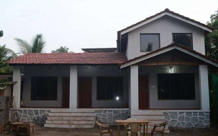 an elegant cottage with sloped roof in Alibaug