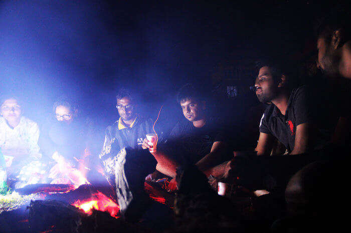 a group of people enjoying bonfire