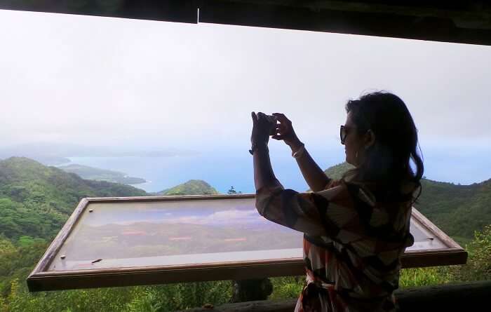 Woman clicking a picture in Seychelles
