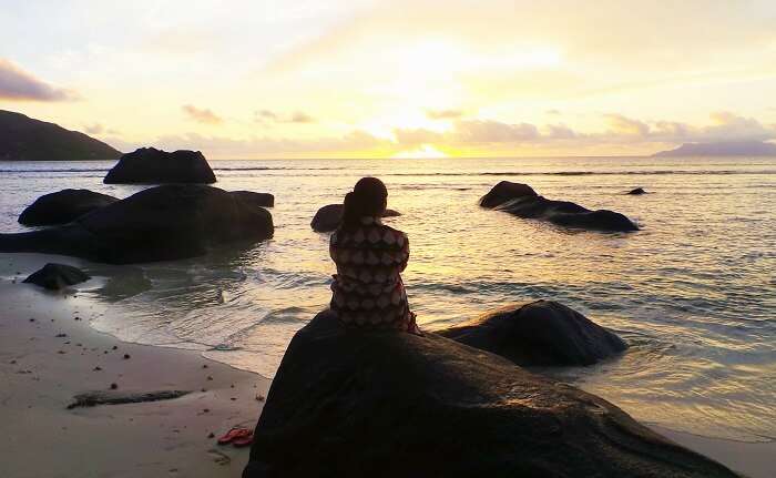 Woman enjoying sunset in Seychelles