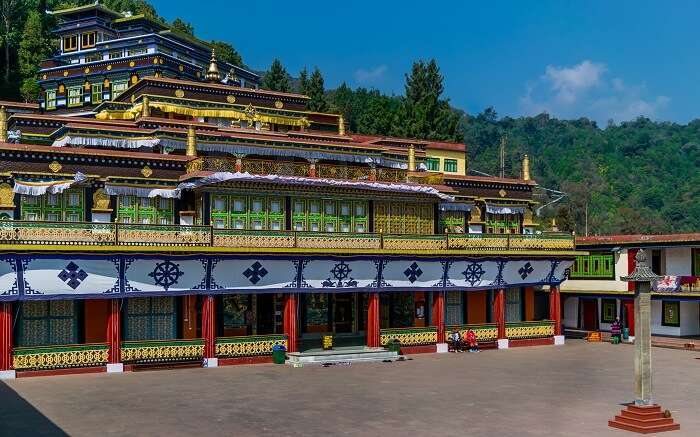 A view of Rumtek Monastery in Sikkim surrounded by greenery 